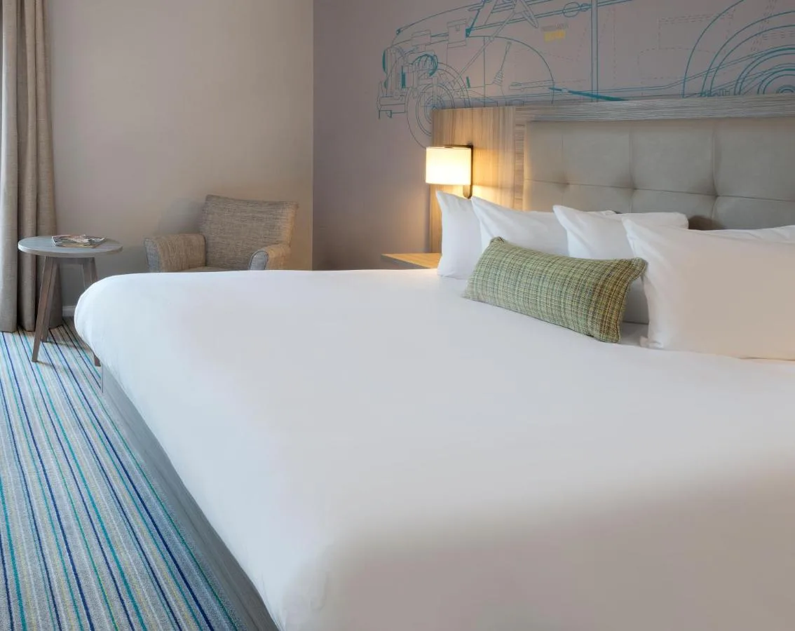 a large white bed in a hotel room at Leonardo Royal Hotel Oxford in Oxford